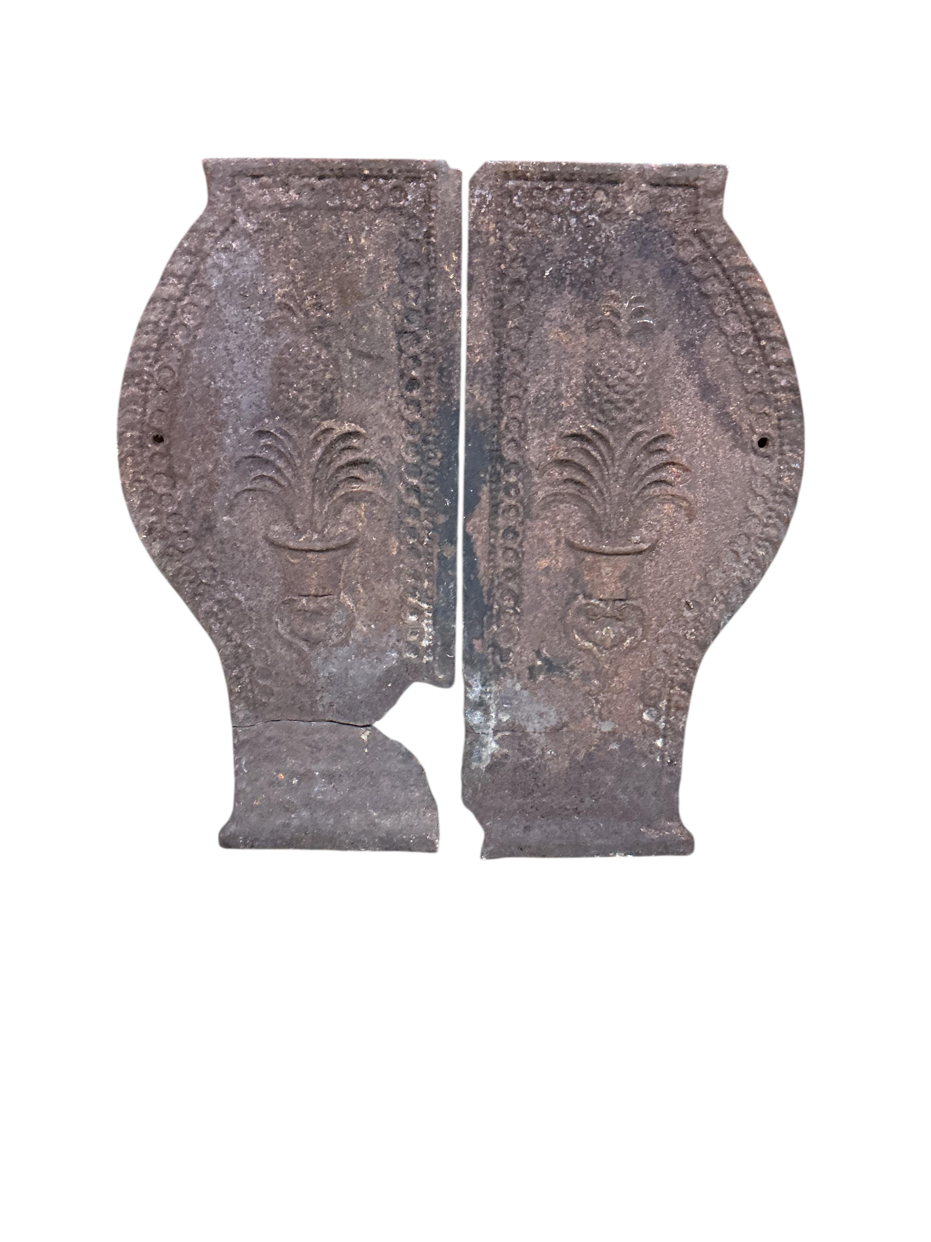 Three pairs of Victorian cast iron fire dogs and a fireback, damaged